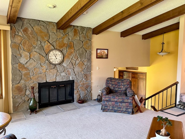 living room with carpet, beamed ceiling, and a stone fireplace