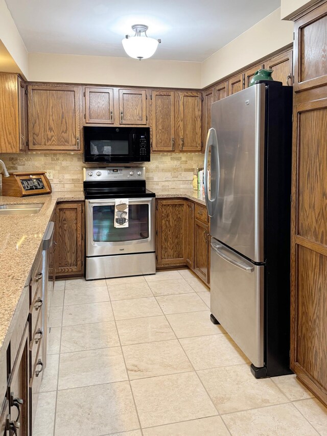 7864 Demontreville Trl N, Lake Elmo, MN 55042 - kitchen with stainless steel appliances, a sink, tasteful backsplash, and light stone counters