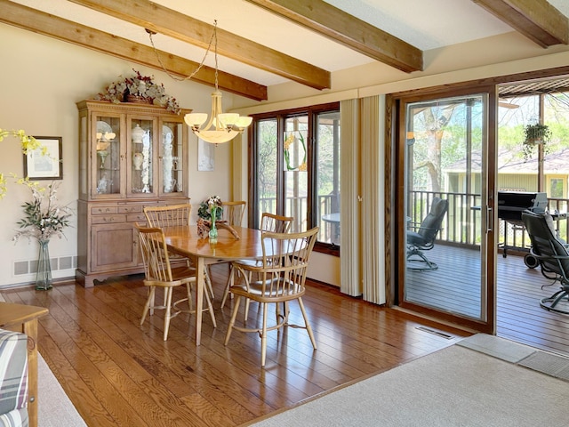 7864 Demontreville Trl N, Lake Elmo, MN 55042 - dining room featuring a chandelier, dark wood finished floors, beam ceiling, and healthy amount of natural light