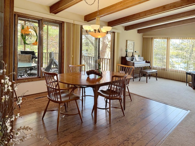7864 Demontreville Trl N, Lake Elmo, MN 55042 - dining space featuring a chandelier, wood-type flooring, and beam ceiling