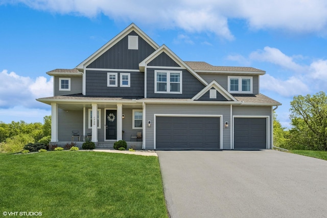 4738 Maas Ct, Minnetrista, MN 55375 - view of front of property with asphalt driveway, an attached garage, a front yard, covered porch, and board and batten siding
