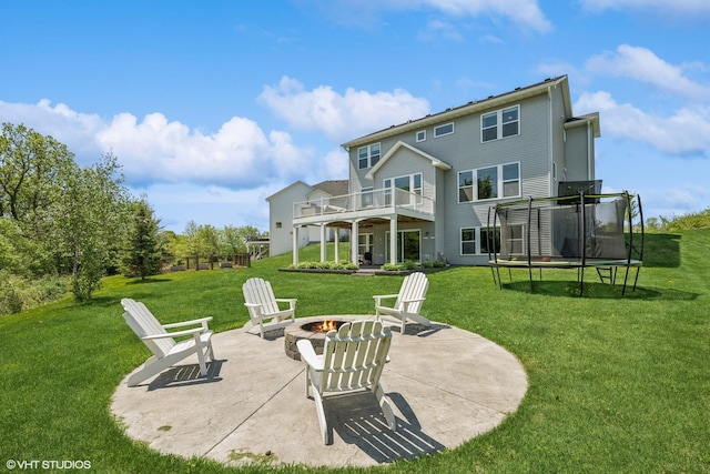 4738 Maas Ct, Minnetrista, MN 55375 - back of property featuring an outdoor fire pit, a patio area, a trampoline, a balcony, and a yard
