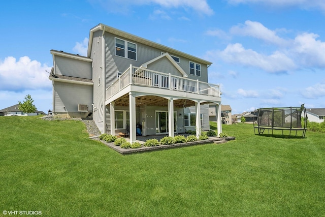 4738 Maas Ct, Minnetrista, MN 55375 - back of property with a trampoline, a wooden deck, a yard, a patio, and cooling unit