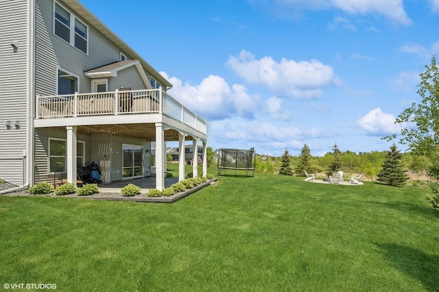 4738 Maas Ct, Minnetrista, MN 55375 - view of grassy yard with a patio area, a trampoline, and a deck