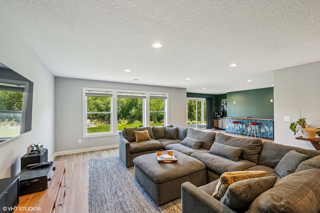 4738 Maas Ct, Minnetrista, MN 55375 - living room featuring light wood-style flooring, recessed lighting, a textured ceiling, and baseboards
