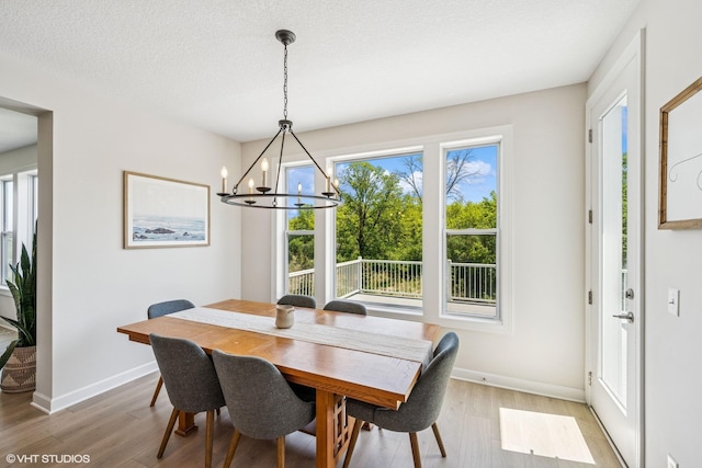 4738 Maas Ct, Minnetrista, MN 55375 - dining area with light wood finished floors, a chandelier, and baseboards