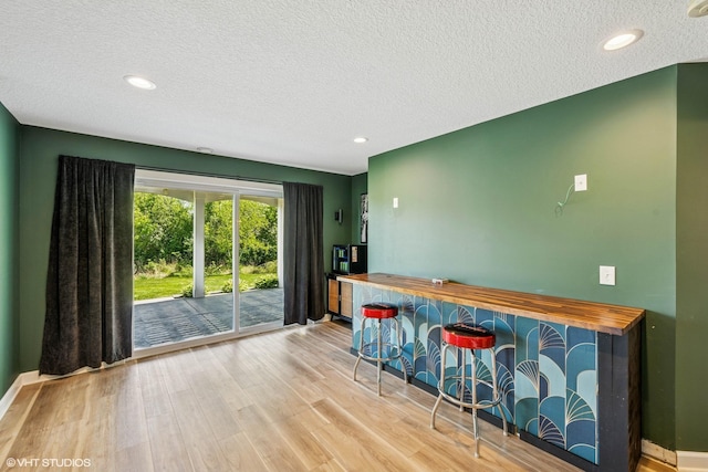4738 Maas Ct, Minnetrista, MN 55375 - bar featuring a textured ceiling, wood finished floors, recessed lighting, and baseboards