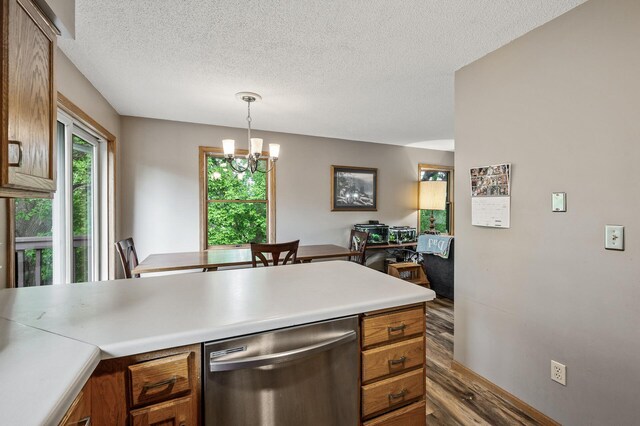 14250 Upper 54th St N, Oak Park Heights, MN 55082 - kitchen with stainless steel dishwasher, a textured ceiling, brown cabinets, wood finished floors, and a chandelier