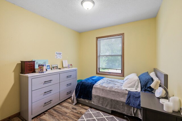 14250 Upper 54th St N, Oak Park Heights, MN 55082 - bedroom featuring wood finished floors and a textured ceiling