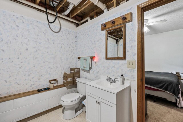 14250 Upper 54th St N, Oak Park Heights, MN 55082 - ensuite bathroom featuring wallpapered walls, toilet, vanity, tile patterned flooring, and a ceiling fan