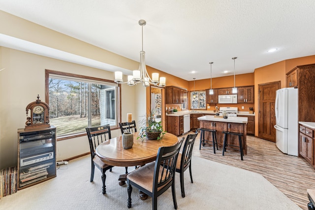 dining room with baseboards, a notable chandelier, and recessed lighting