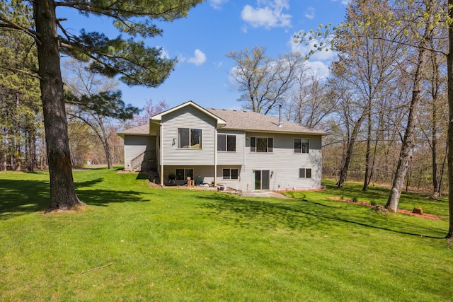 rear view of property with a lawn