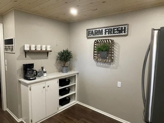 bar with wooden ceiling, freestanding refrigerator, baseboards, and dark wood-style floors