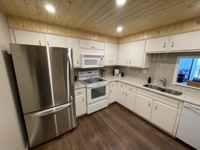 kitchen featuring white appliances, wood ceiling, light countertops, and a sink