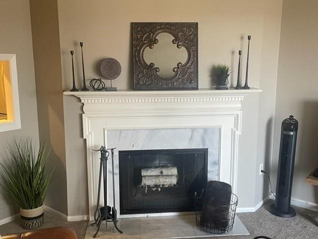 room details featuring a fireplace and baseboards