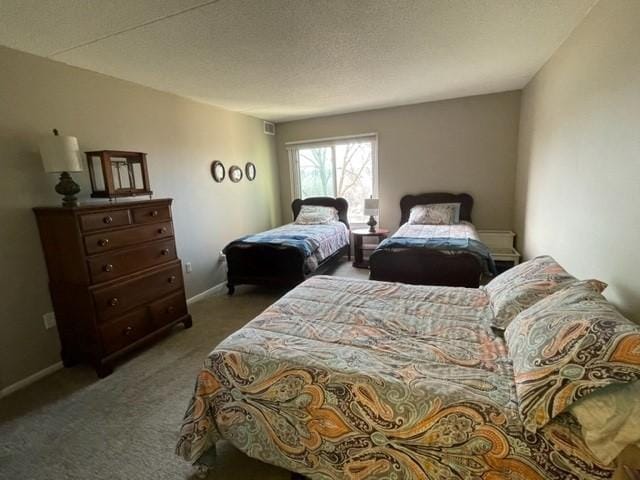bedroom with baseboards and carpet floors