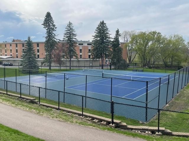view of tennis court with fence