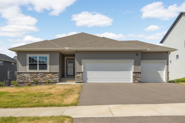 7107 184th St W, Lakeville, MN 55044 - prairie-style home featuring driveway, a garage, stone siding, and a shingled roof