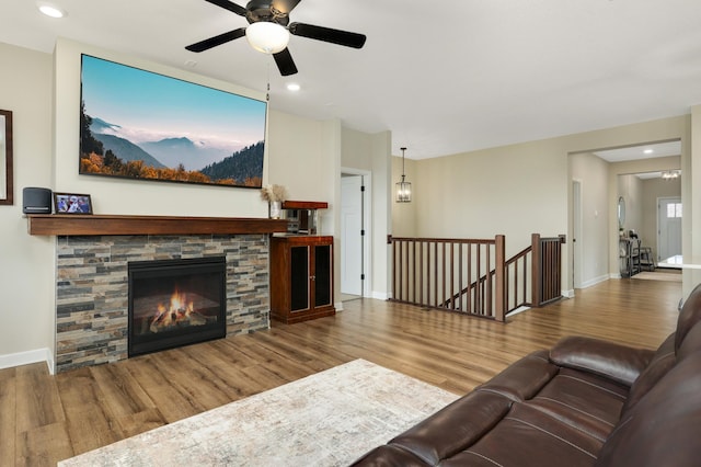7107 184th St W, Lakeville, MN 55044 - living area featuring wood finished floors, ceiling fan, baseboards, recessed lighting, and a stone fireplace