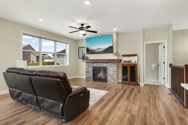 7107 184th St W, Lakeville, MN 55044 - living area with wood finished floors, a ceiling fan, baseboards, a stone fireplace, and recessed lighting