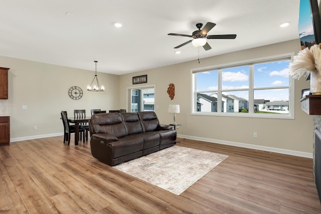 7107 184th St W, Lakeville, MN 55044 - living room with a chandelier, light wood-style flooring, ceiling fan, baseboards, and recessed lighting