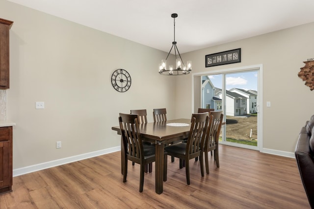 7107 184th St W, Lakeville, MN 55044 - dining room featuring wood finished floors, a chandelier, and baseboards