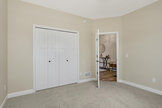 7107 184th St W, Lakeville, MN 55044 - unfurnished bedroom featuring light colored carpet, baseboards, and a closet
