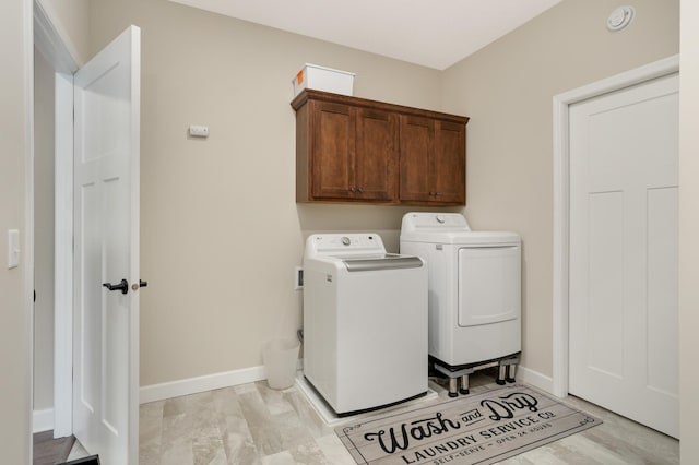 7107 184th St W, Lakeville, MN 55044 - laundry area featuring washer and clothes dryer, cabinet space, and baseboards