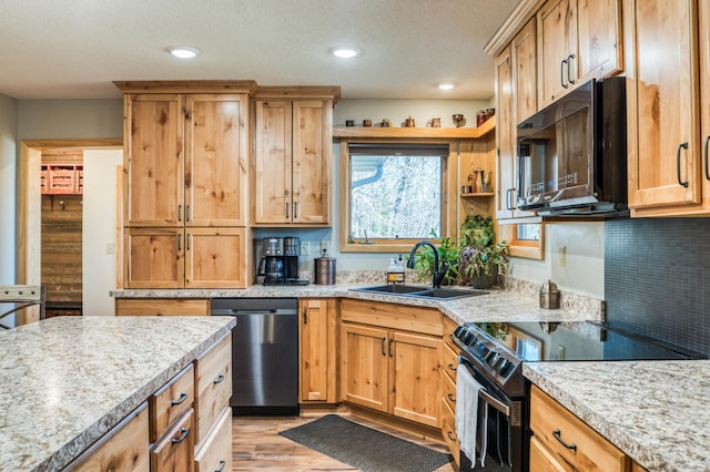 kitchen featuring a sink, range with electric stovetop, dishwasher, light wood finished floors, and black microwave
