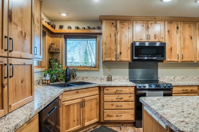 kitchen featuring a textured ceiling, black dishwasher, a sink, stainless steel microwave, and electric stove
