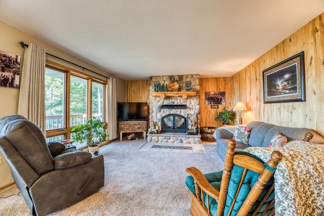 carpeted living area featuring wood walls and a textured ceiling