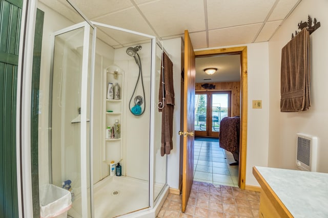bathroom featuring heating unit, vanity, ensuite bath, and a stall shower