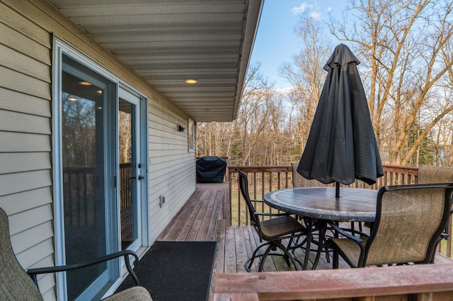 deck with area for grilling and outdoor dining area