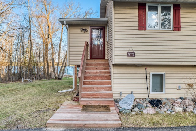 view of exterior entry featuring a yard