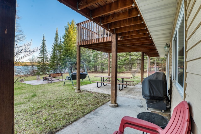 view of patio featuring a fenced backyard, a wooden deck, and grilling area
