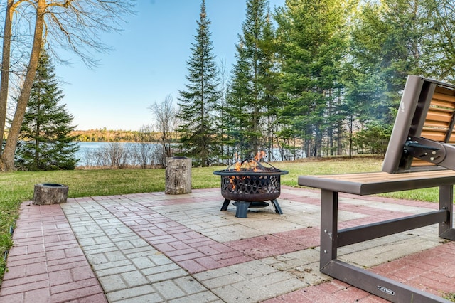 view of patio / terrace featuring a water view and a fire pit