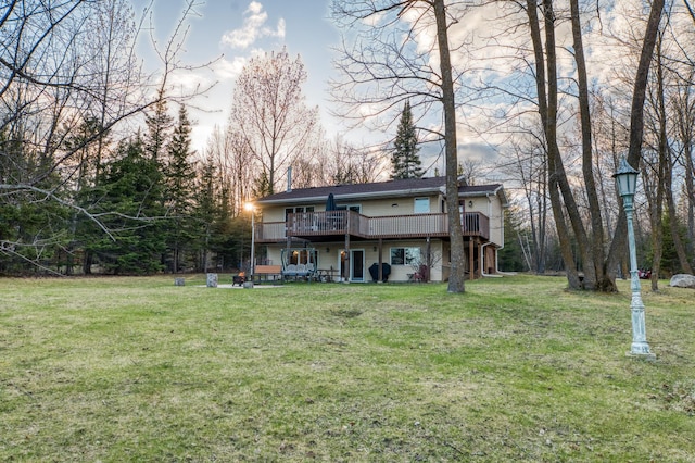 back of house with a yard and a deck