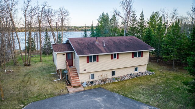 32061 Primrose Ln, Walker, MN 56461 - view of front of house featuring a water view, a front yard, and a shingled roof