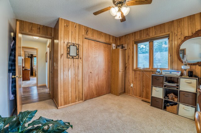32061 Primrose Ln, Walker, MN 56461 - carpeted office featuring wood walls, a ceiling fan, a textured ceiling, and baseboards