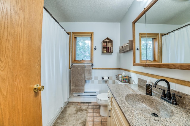 32061 Primrose Ln, Walker, MN 56461 - full bath featuring healthy amount of natural light, toilet, vanity, tile patterned flooring, and a textured ceiling