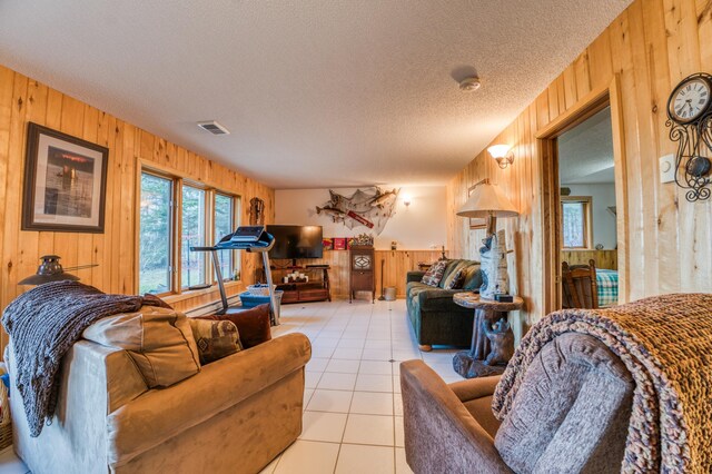 32061 Primrose Ln, Walker, MN 56461 - living area with wood walls, a textured ceiling, and light tile patterned floors