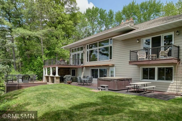 802 Flos Ct, Lincoln Twp, WI 54001 - back of house featuring a hot tub, a patio area, a yard, a wooden deck, and a chimney