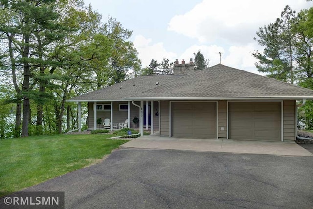 802 Flos Ct, Lincoln Twp, WI 54001 - view of front of house with a chimney, a garage, a front lawn, a shingled roof, and driveway