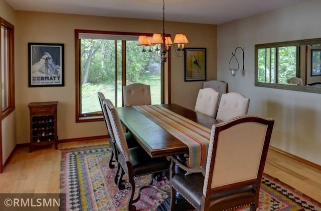 802 Flos Ct, Lincoln Twp, WI 54001 - dining space featuring a chandelier, plenty of natural light, and light wood-style flooring