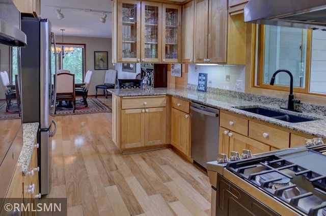 802 Flos Ct, Lincoln Twp, WI 54001 - kitchen featuring stainless steel appliances, a sink, light wood finished floors, and rail lighting