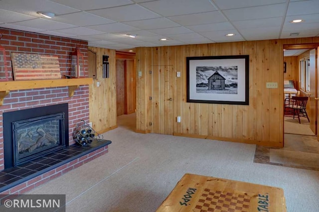 802 Flos Ct, Lincoln Twp, WI 54001 - carpeted living area featuring baseboards, a brick fireplace, wood walls, a paneled ceiling, and recessed lighting