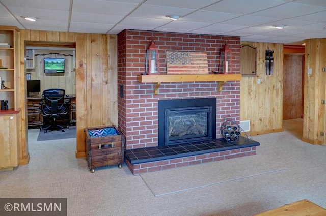 802 Flos Ct, Lincoln Twp, WI 54001 - living area with carpet flooring, wooden walls, an office area, a fireplace, and a drop ceiling