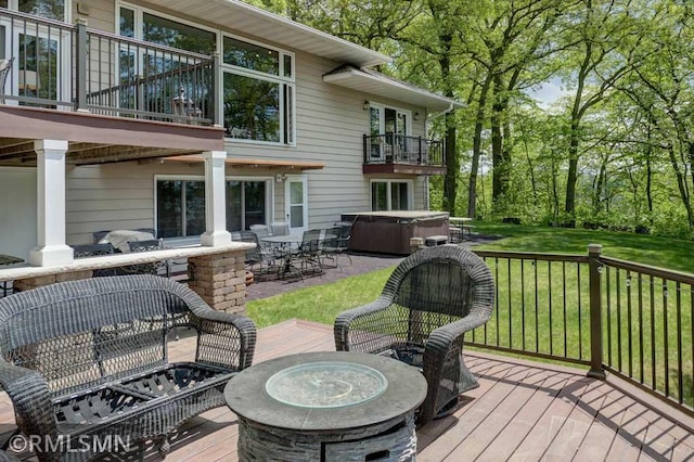 802 Flos Ct, Lincoln Twp, WI 54001 - deck featuring a hot tub, a fire pit, a lawn, and a patio area