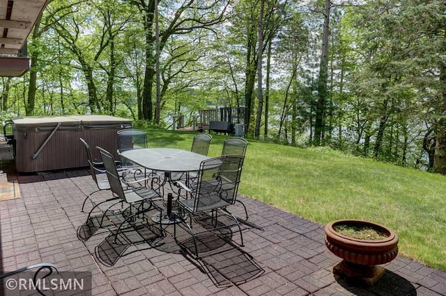 802 Flos Ct, Lincoln Twp, WI 54001 - view of patio / terrace featuring a hot tub, outdoor dining area, and view of wooded area