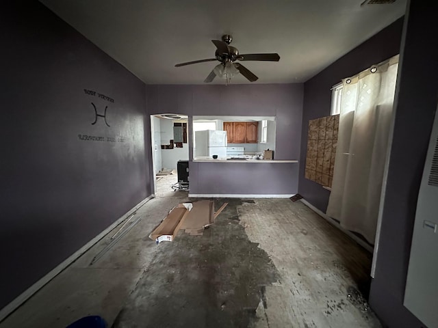 interior space featuring baseboards and ceiling fan